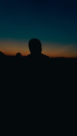 Outdoor portrait of a young adult against a vibrant Florida sunset backdrop.
