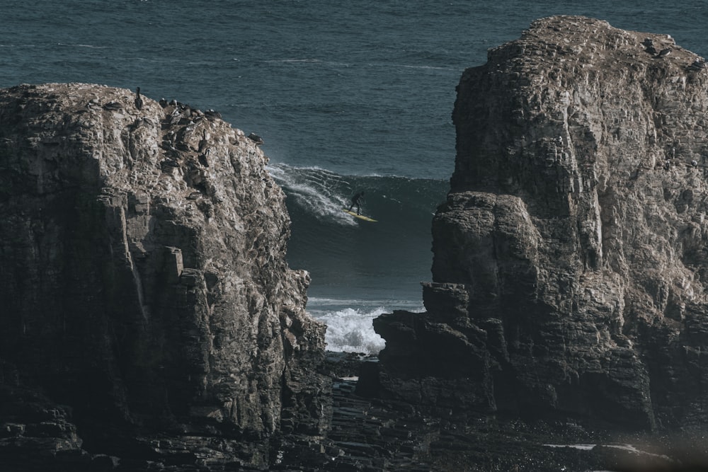 a rocky cliff next to the ocean