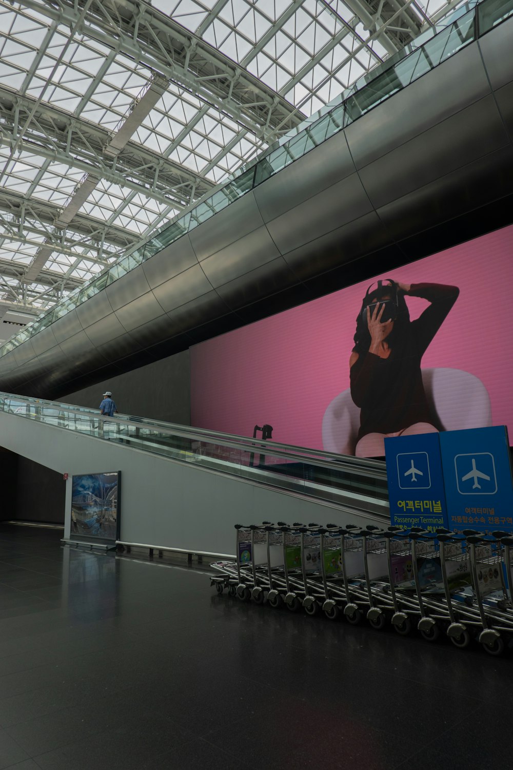 a person taking a picture of herself in a mirror in a shopping mall