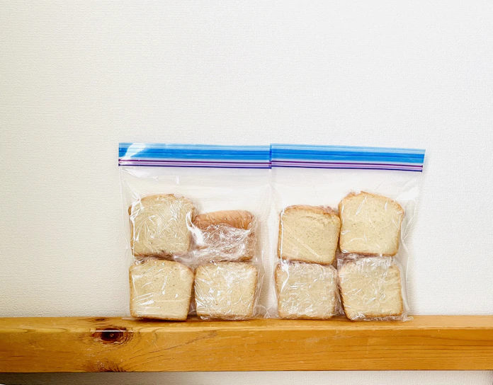 Close-up of eco-friendly slider zipper bags neatly arranged on a wooden kitchen counter.
