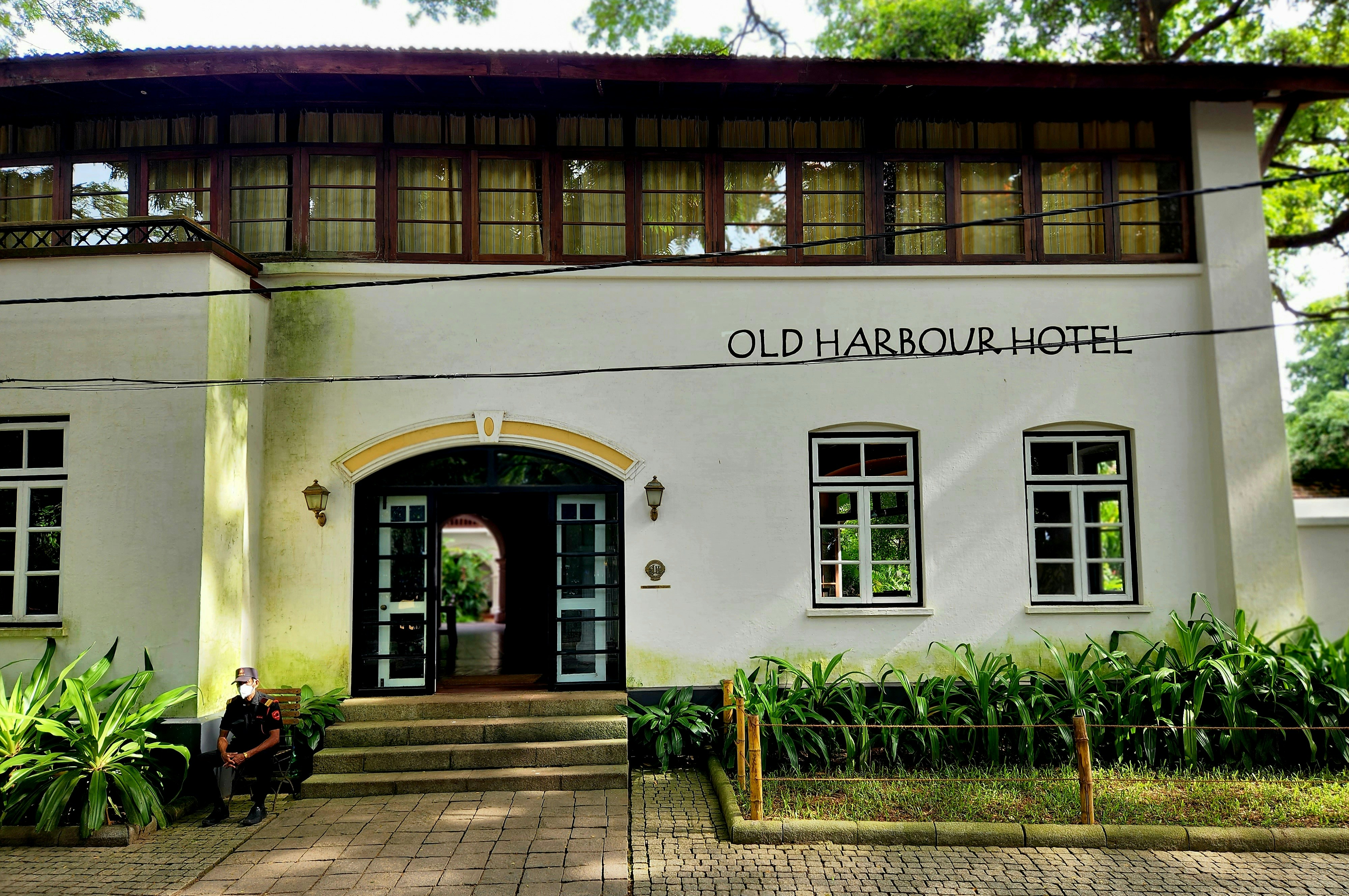 a person sitting on a bench outside a building