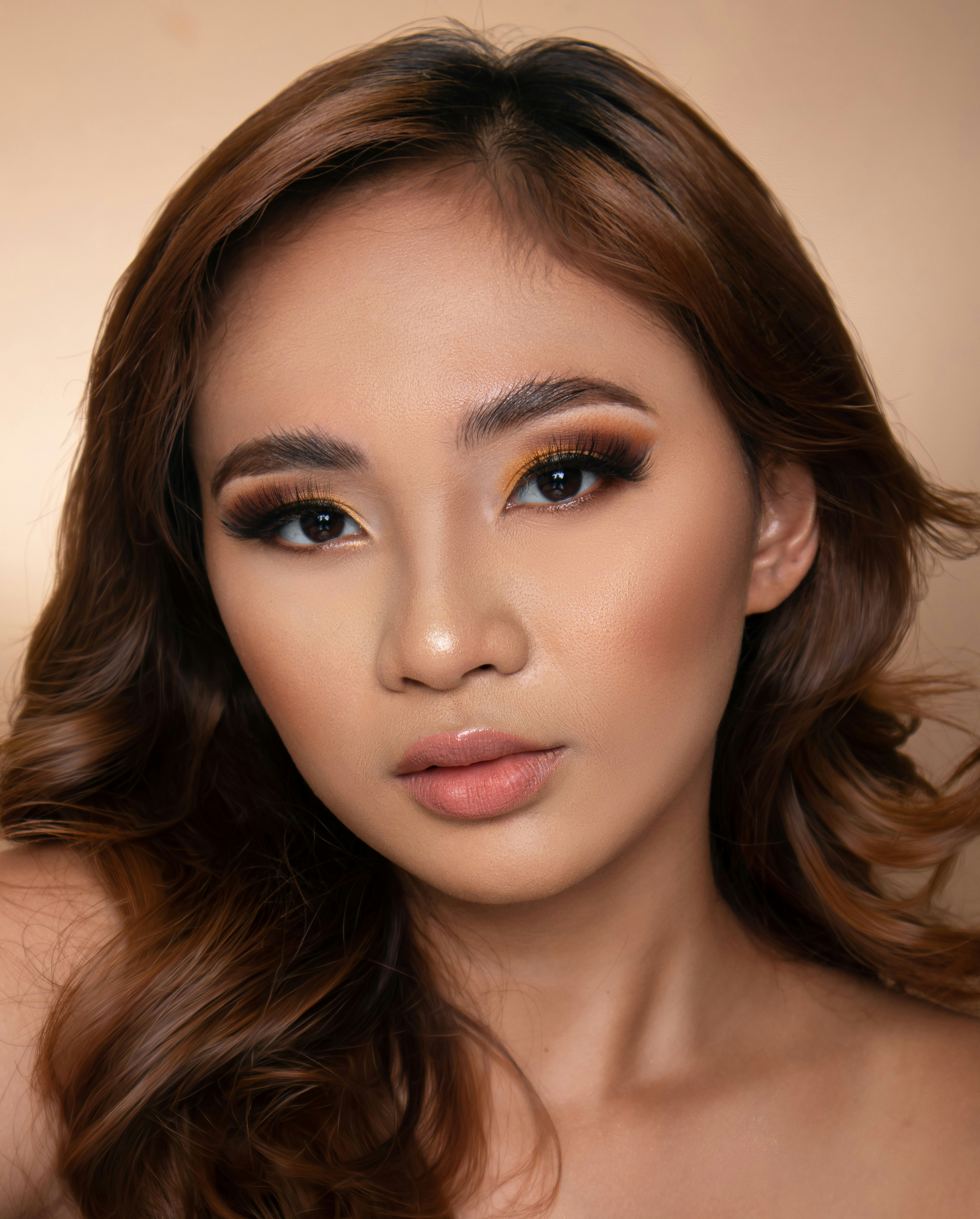 A woman with styled hair and dramatic eye makeup