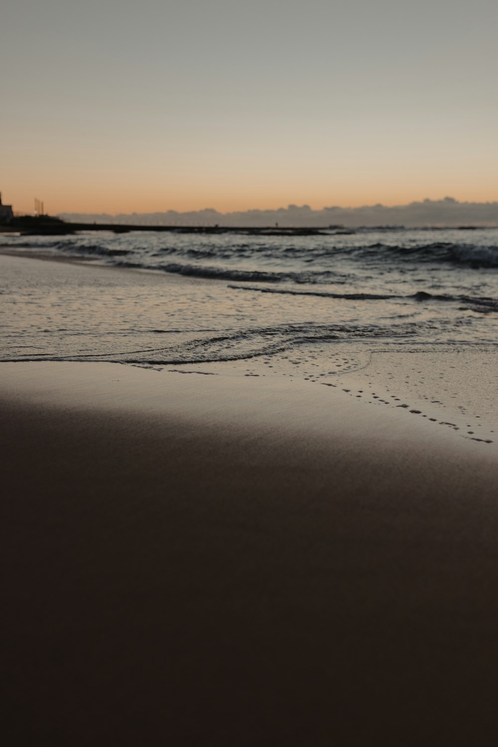 una spiaggia con onde e un tramonto