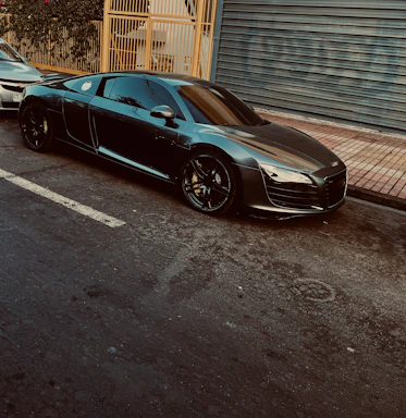 A sleek, shiny sports car parked on a city street at sunset, ready for detailing.
