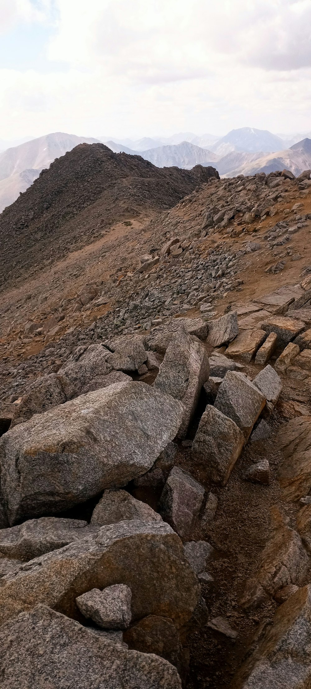 a rocky landscape with mountains in the background