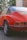 a red car parked on a brick road