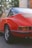 a red car parked on a brick road
