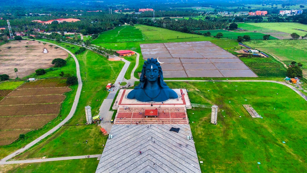 a statue of a person on a horse in a field