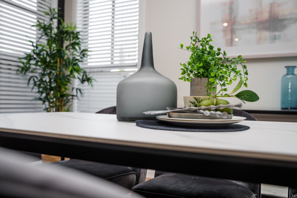 a table with a plant and a plate of food on it