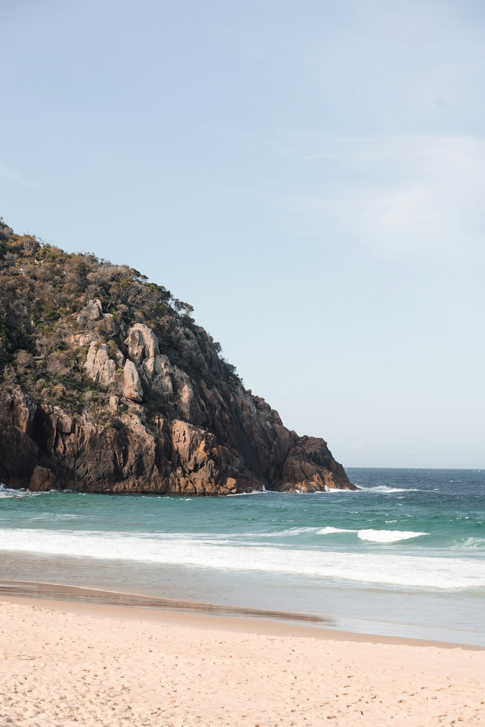 a rocky cliff next to the ocean