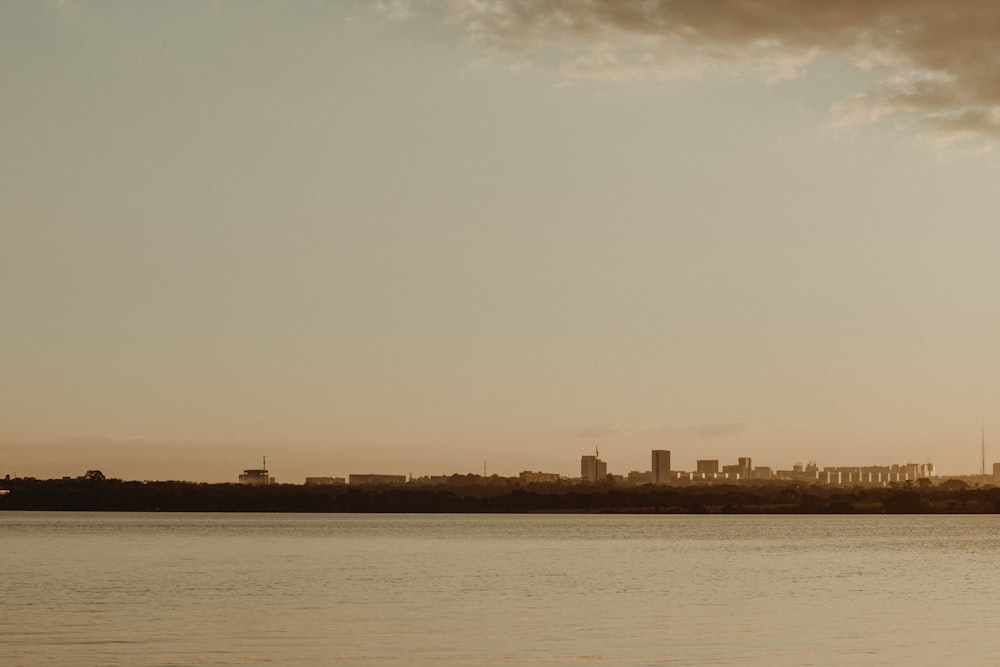 a body of water with a city in the background