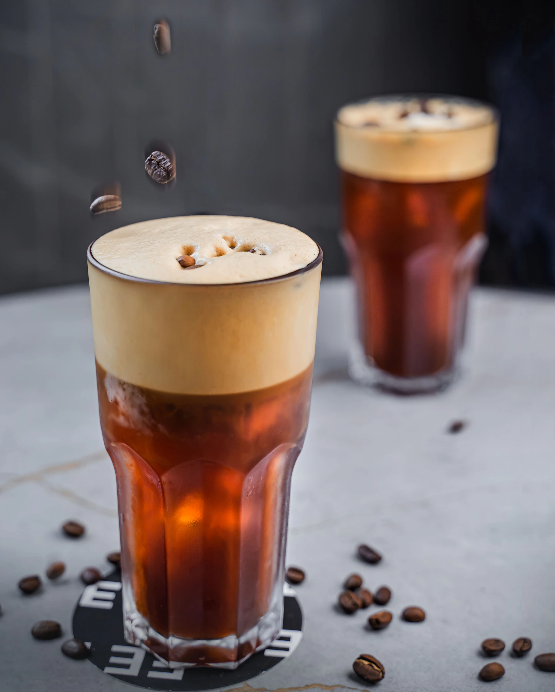 a couple of glasses with liquid in them