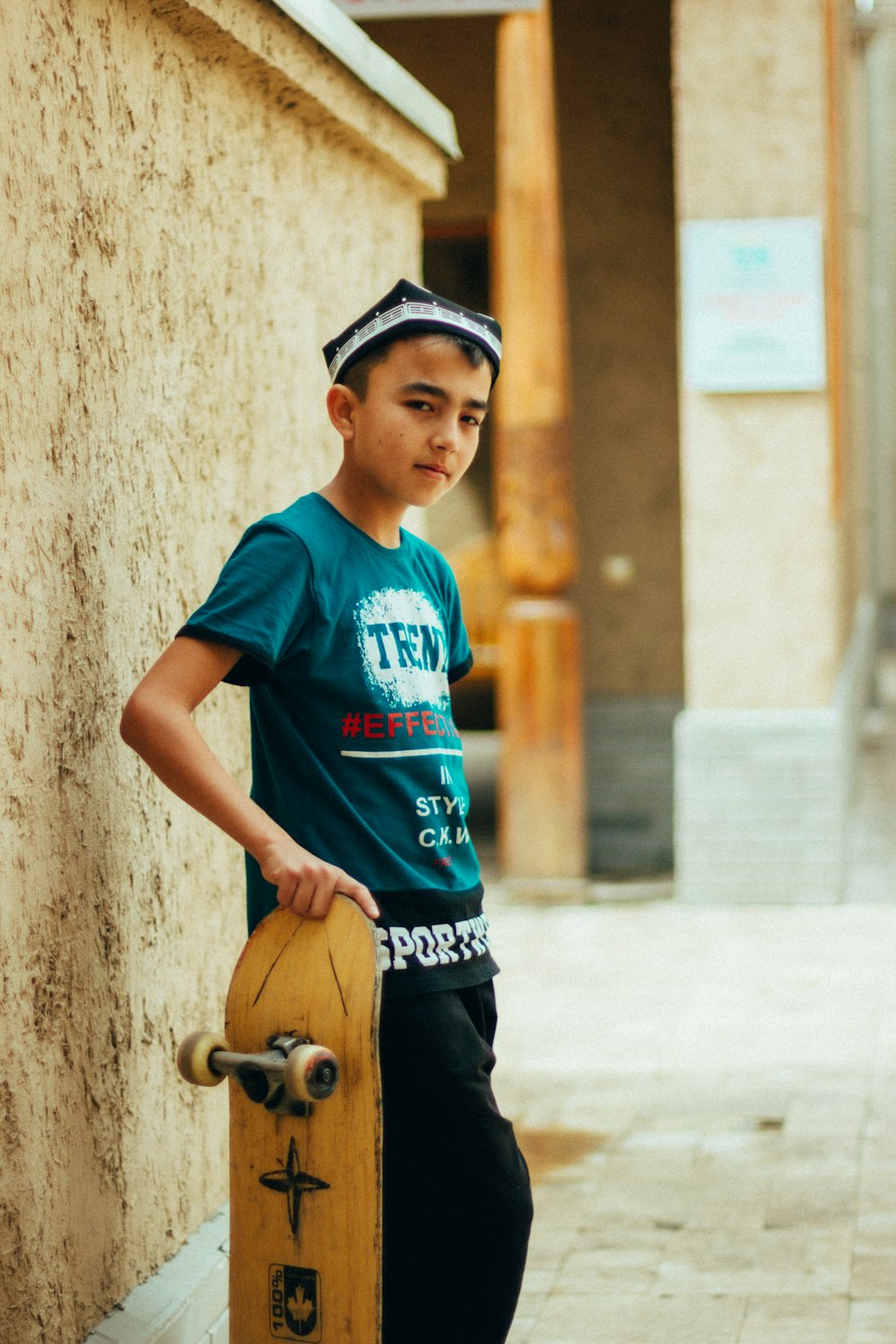 a boy holding a skateboard