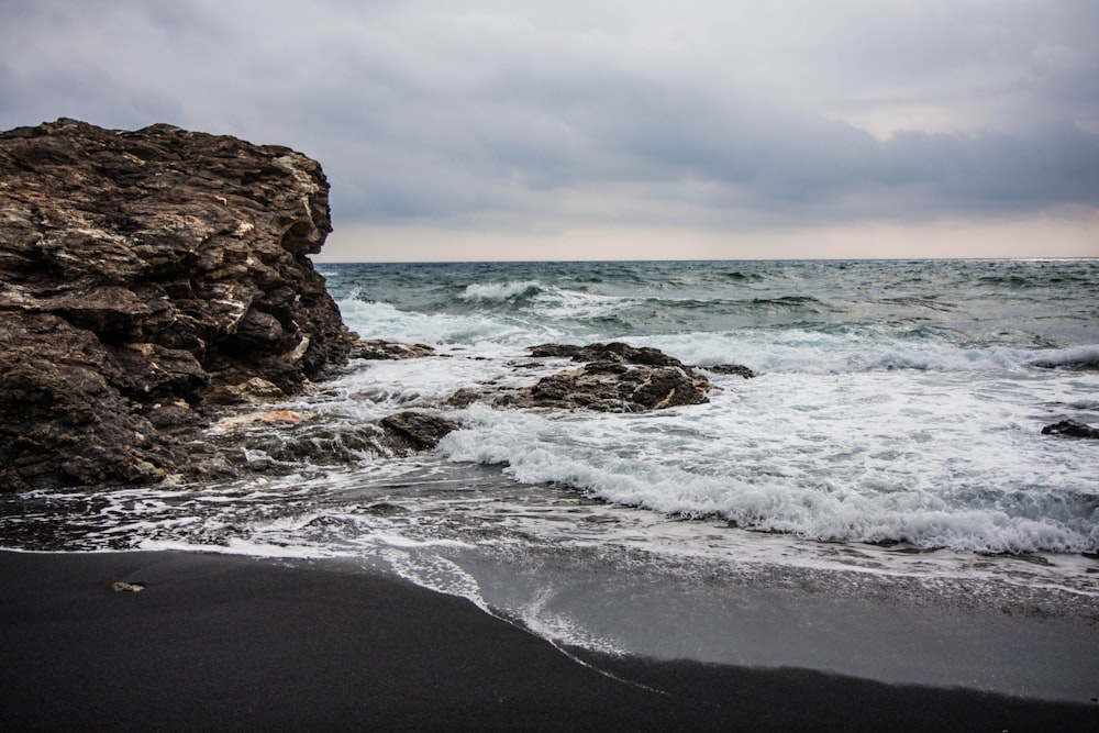 waves crashing against a rock