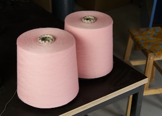 a couple of pink vases on a table