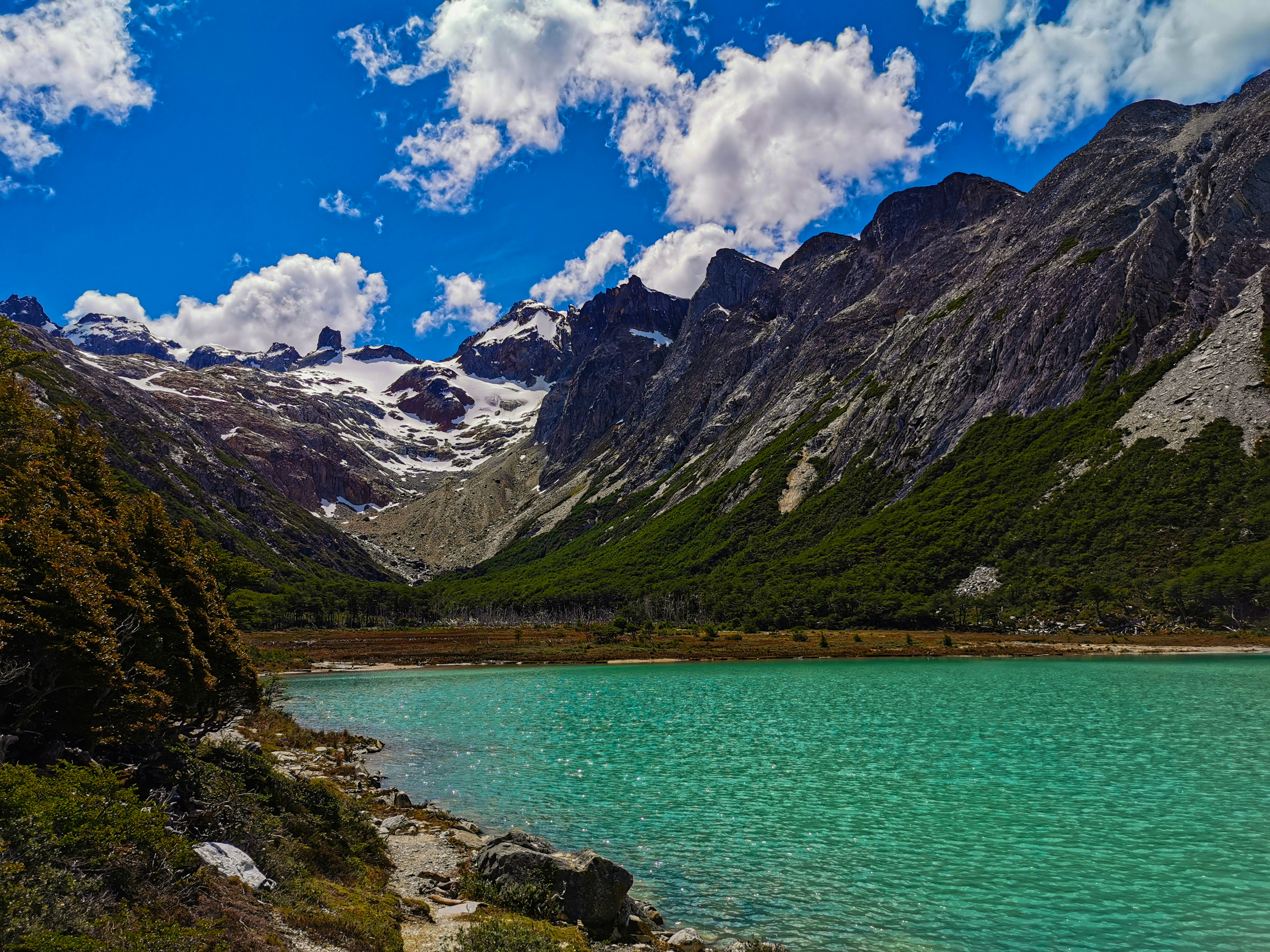 a body of water with mountains in the back