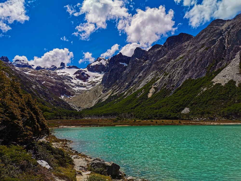 a body of water with mountains in the back