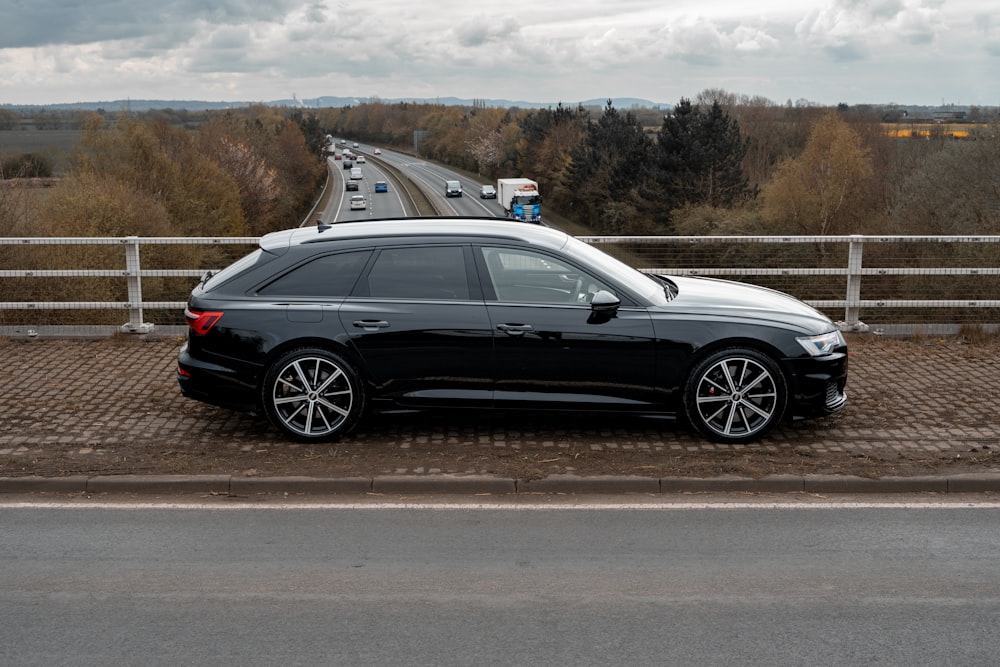 a black car parked on a road