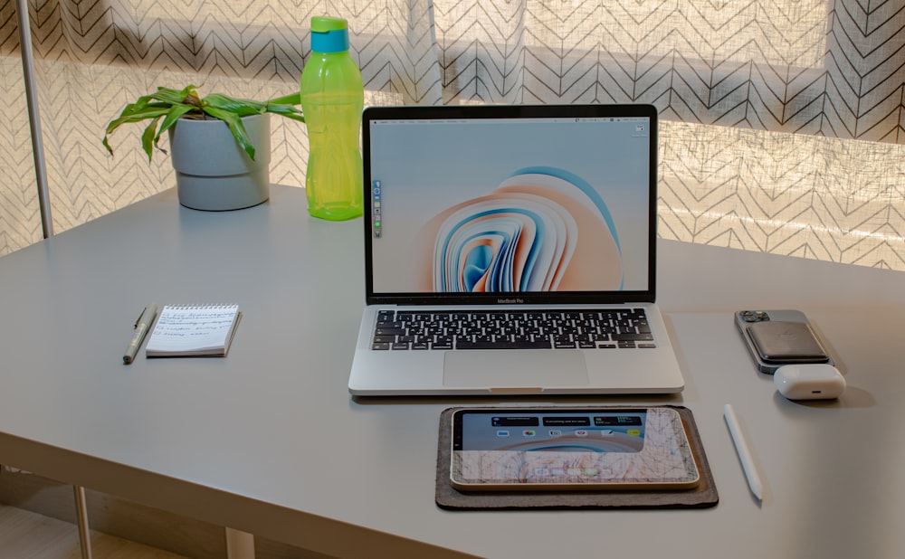 a laptop and a cell phone on a table