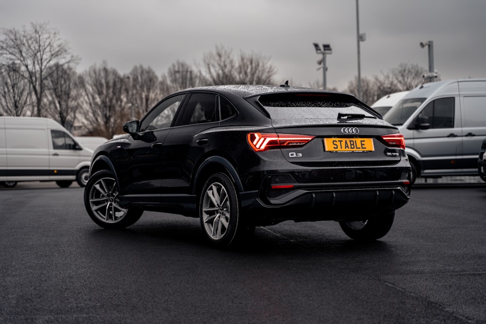 a black car parked in a parking lot