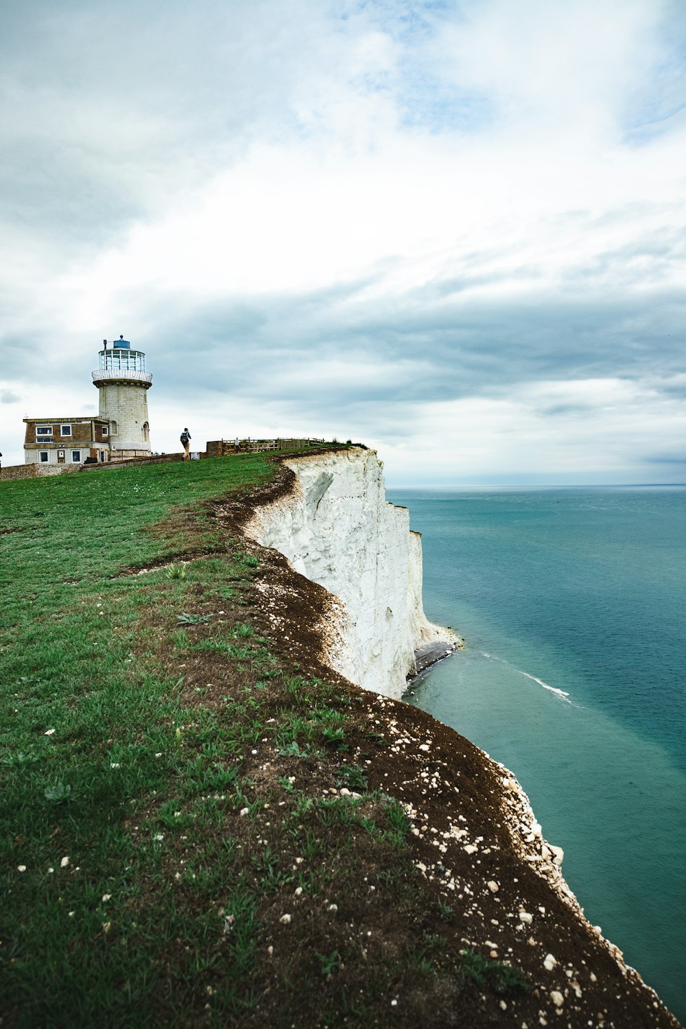 a lighthouse on a cliff by the ocean