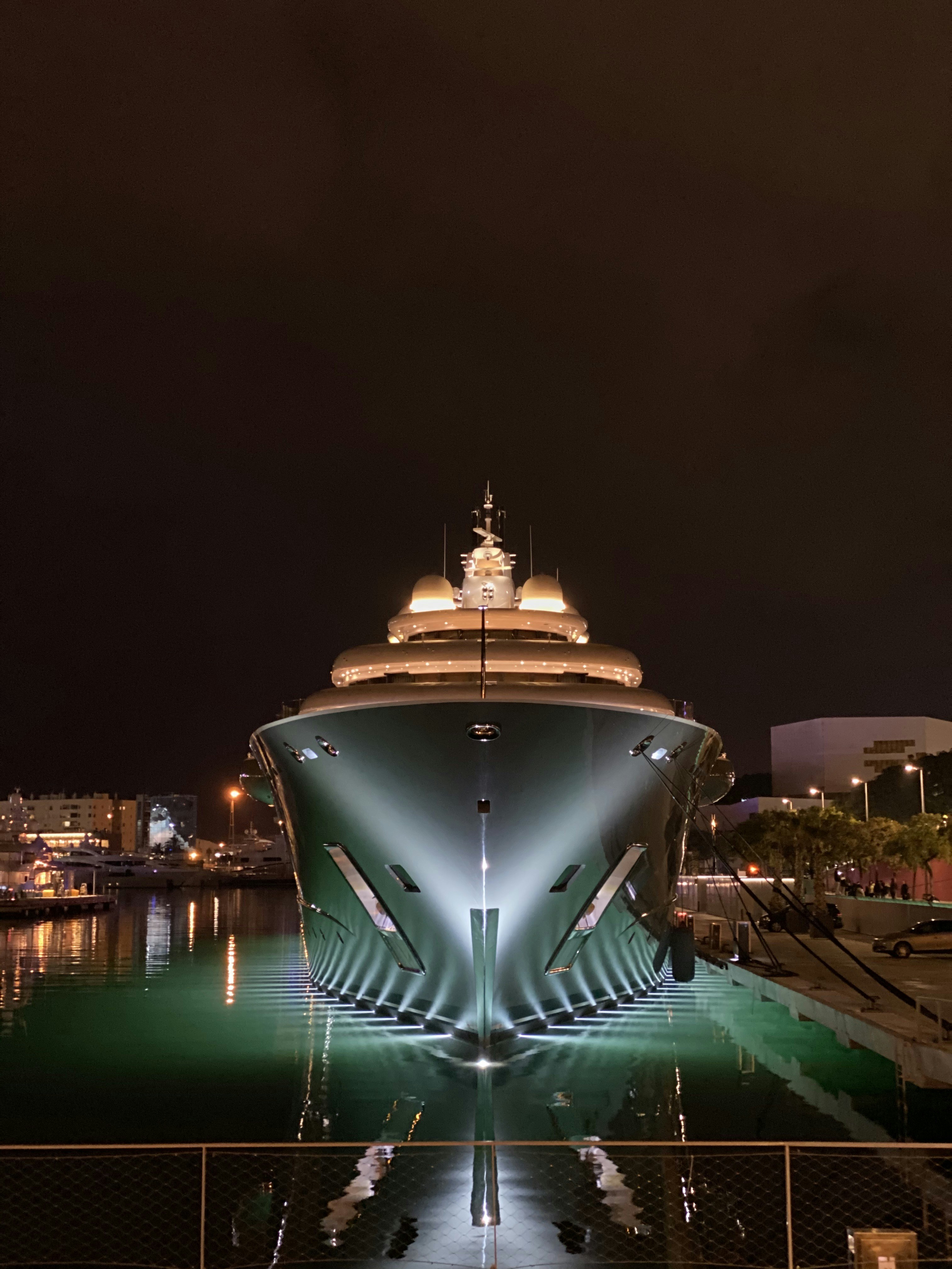 a large building with a dome on top surrounded by water at night