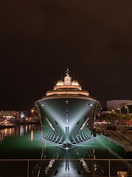 a large building with a dome on top surrounded by water at night