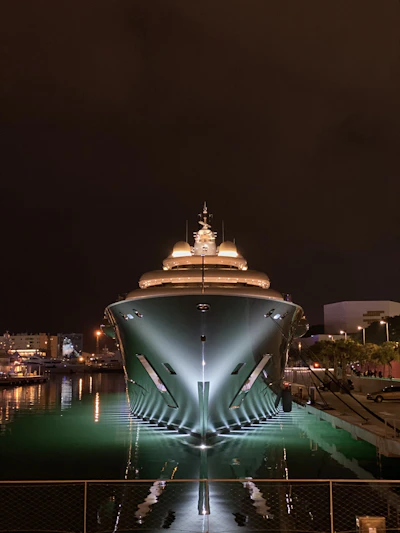 a large building with a dome on top surrounded by water at night
