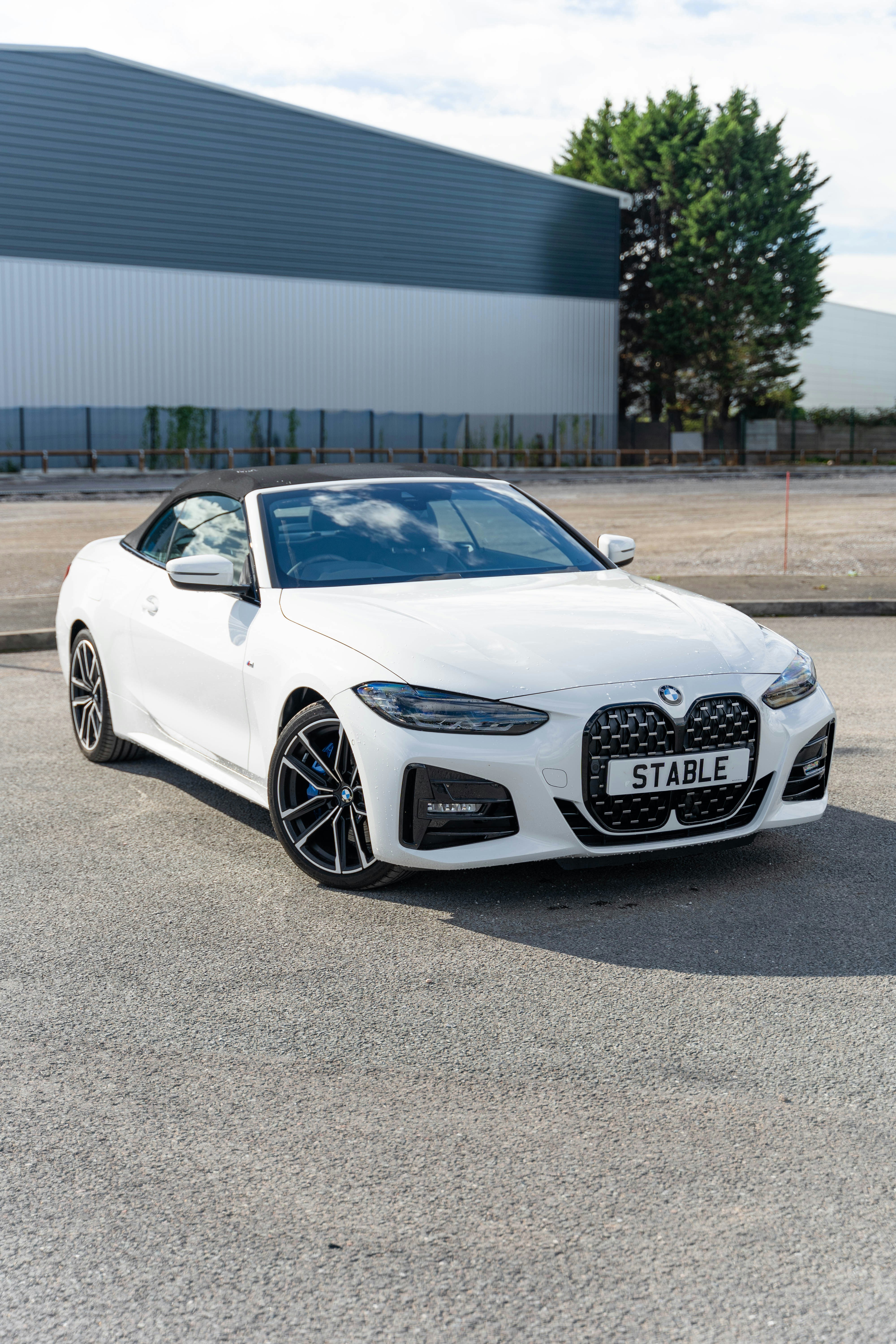 a white car parked in front of a building
