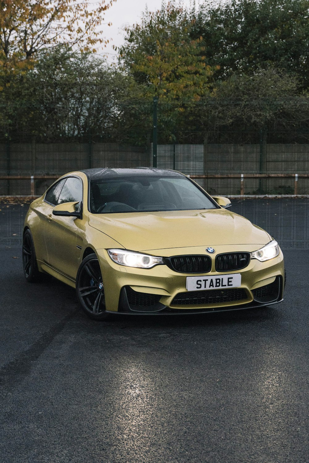 a yellow car parked on a road