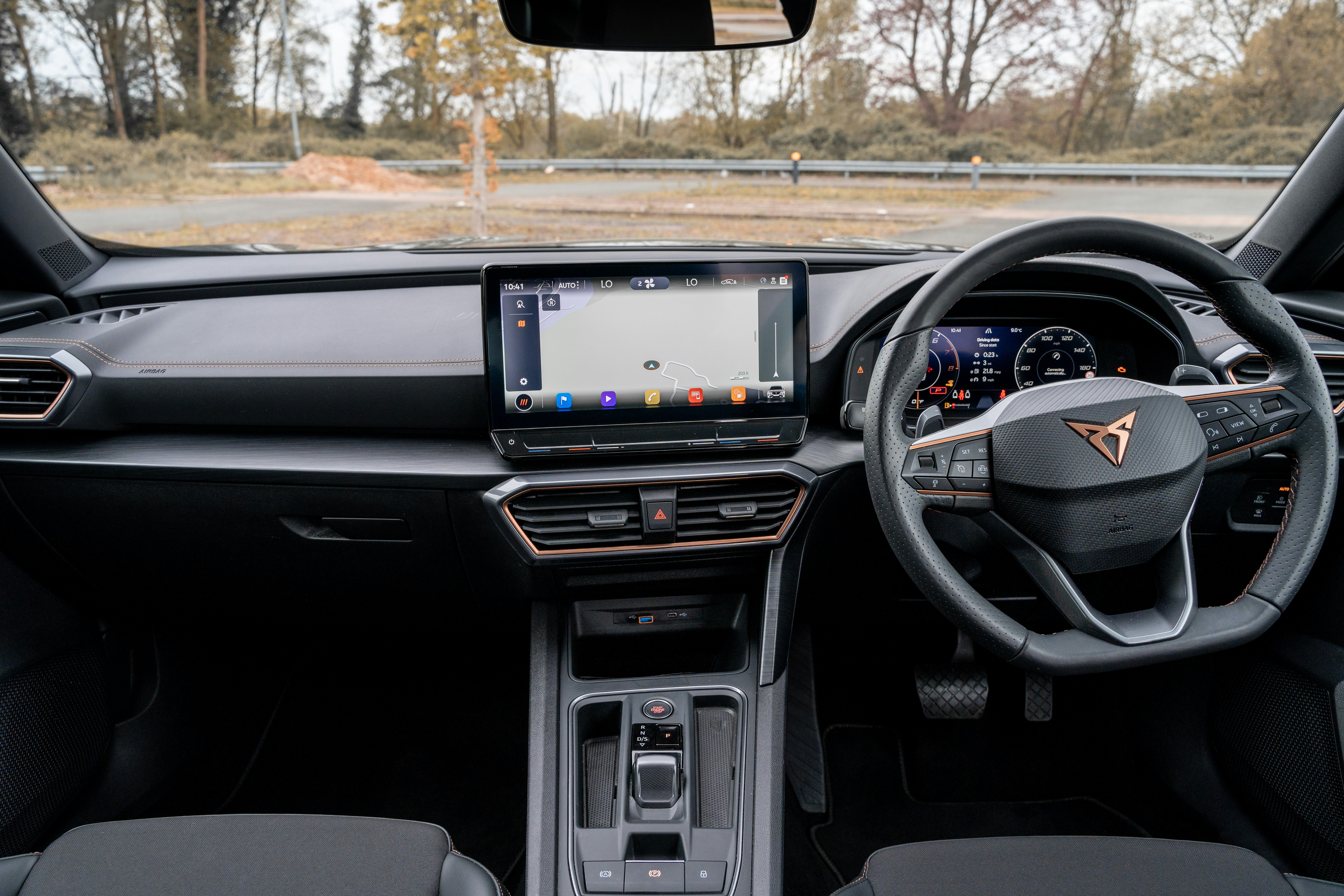 Interior of a Rivian R1S showing digital dashboard and central touchscreen in a modern EV SUV