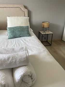a bed with a white blanket and pillows