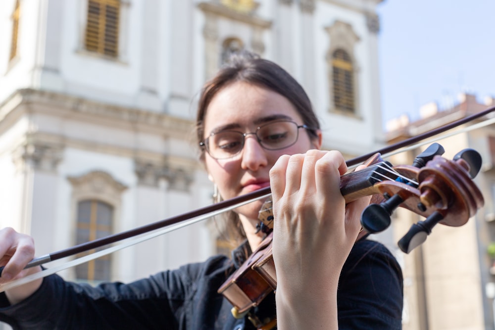 a woman playing a violin