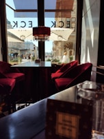 A panoramic view of the cafe’s interior highlighting the dark theme with red and gold decor.