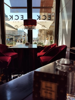 A panoramic view of the cafe’s interior highlighting the dark theme with red and gold decor.