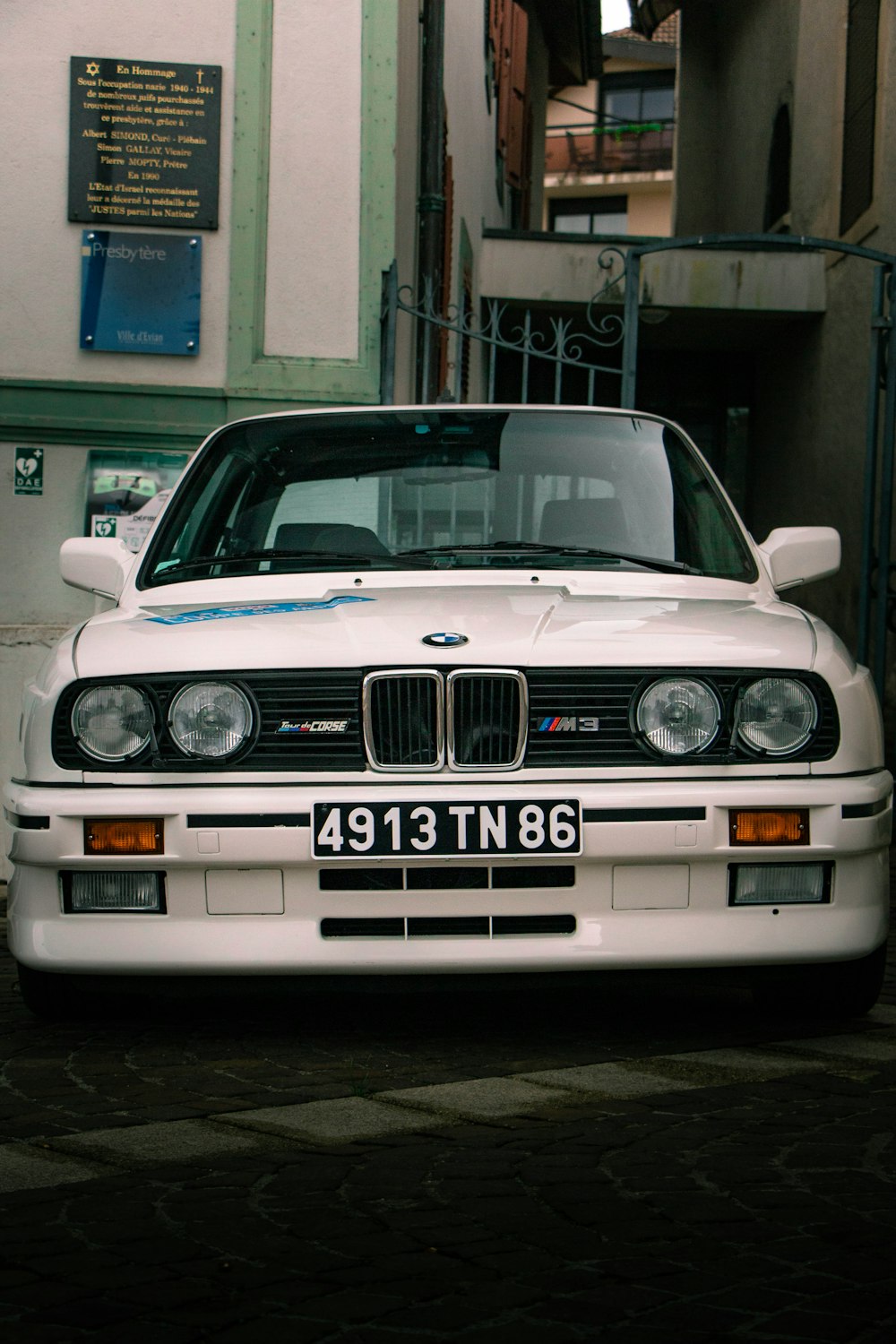 a white car parked on the side of a street