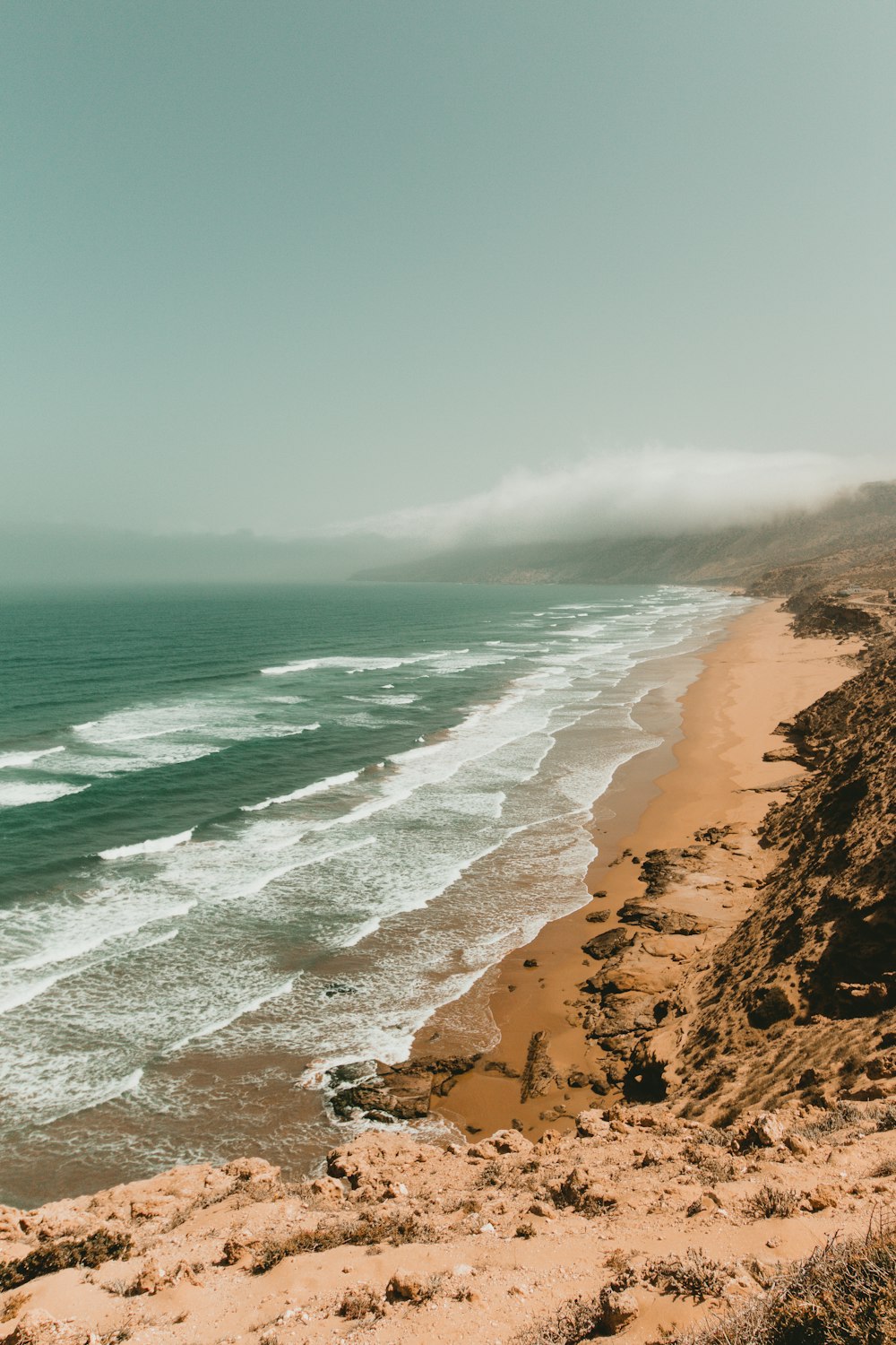 a beach with waves crashing on it