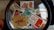A collection of Indian postal stamps viewed through a magnifying glass. The stamps feature various designs, including architectural landmarks, artwork, cultural symbols, and portraits. The magnifying glass emphasizes the details and intricacies of the stamp designs.