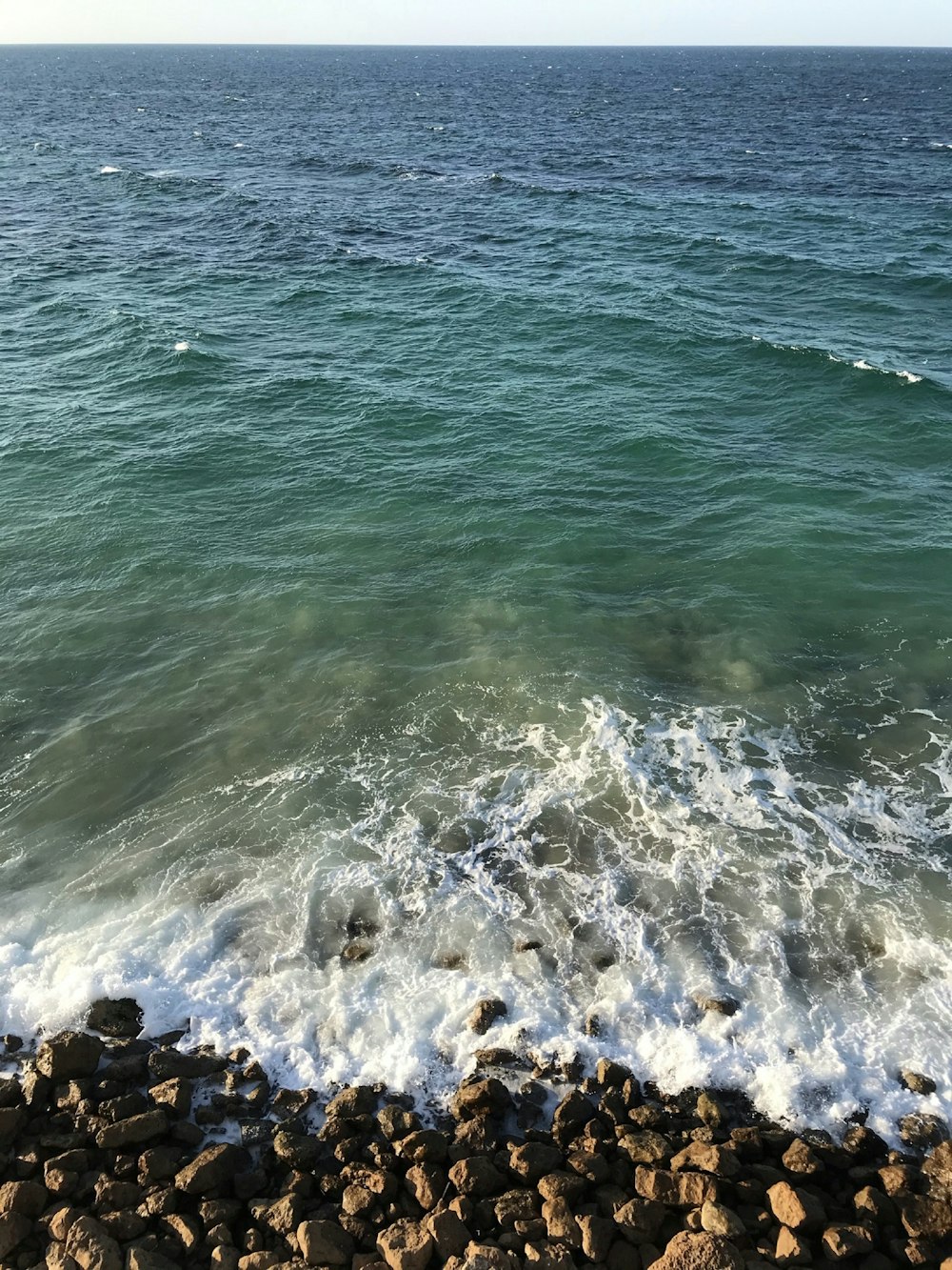 a rocky beach with waves crashing