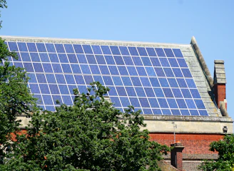 Rooftop covered with sleek photovoltaic panels under a clear blue sky.