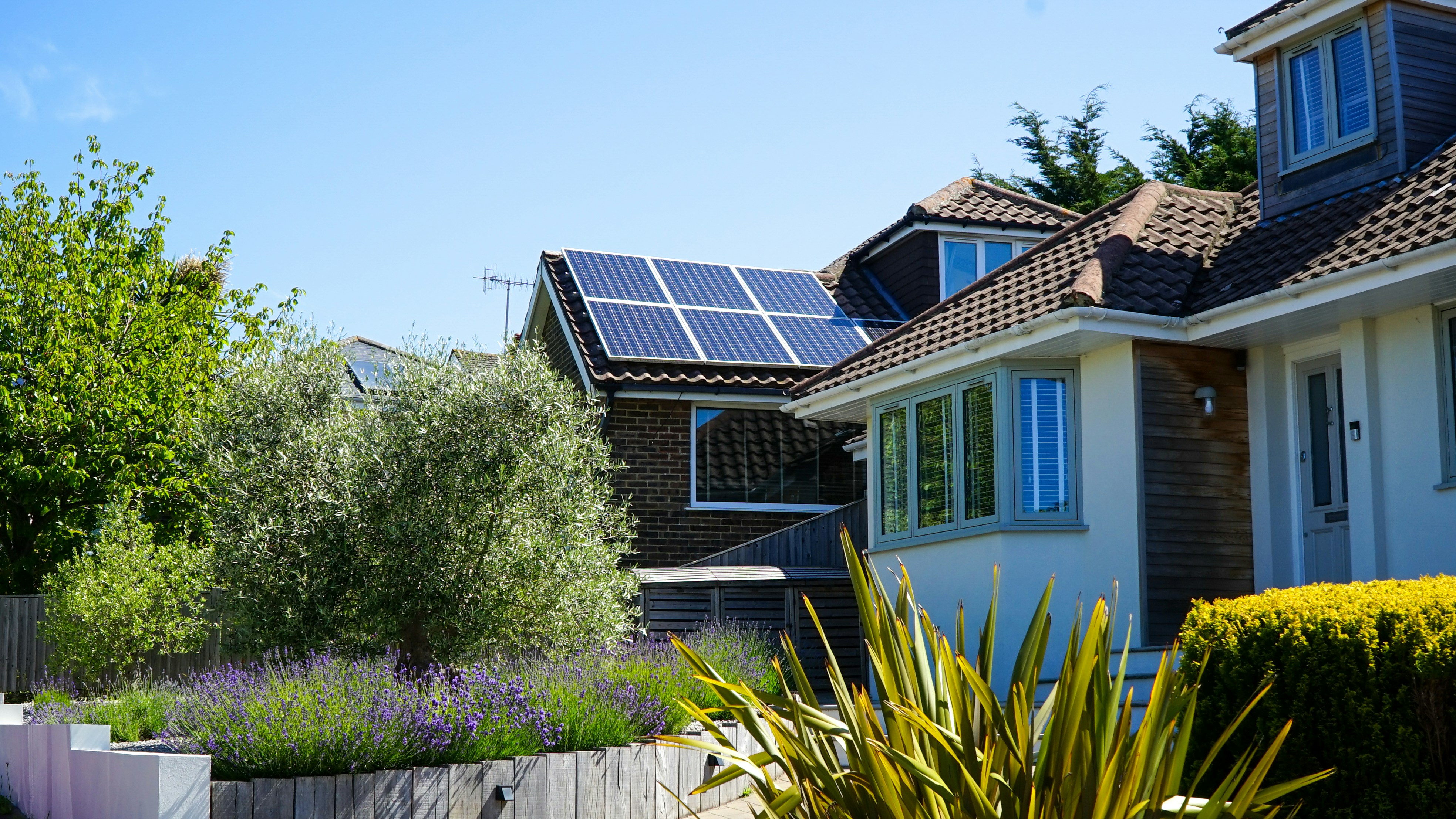 Solar panels in the midday sun on a house roof