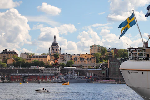 a body of water with boats and buildings in the background
