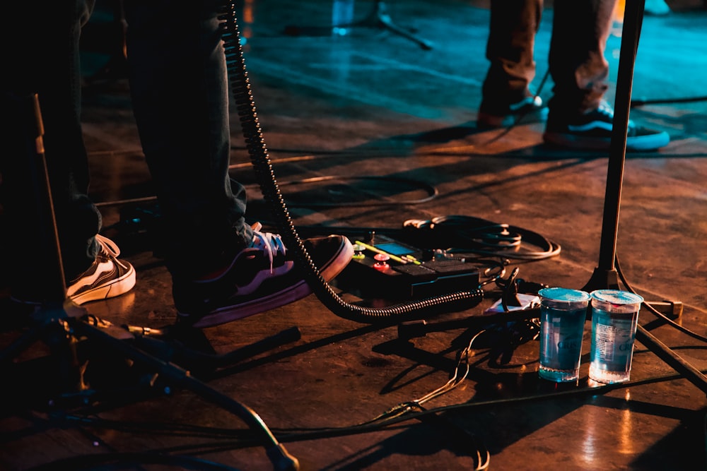 a group of people standing on a stage with a guitar and a microphone