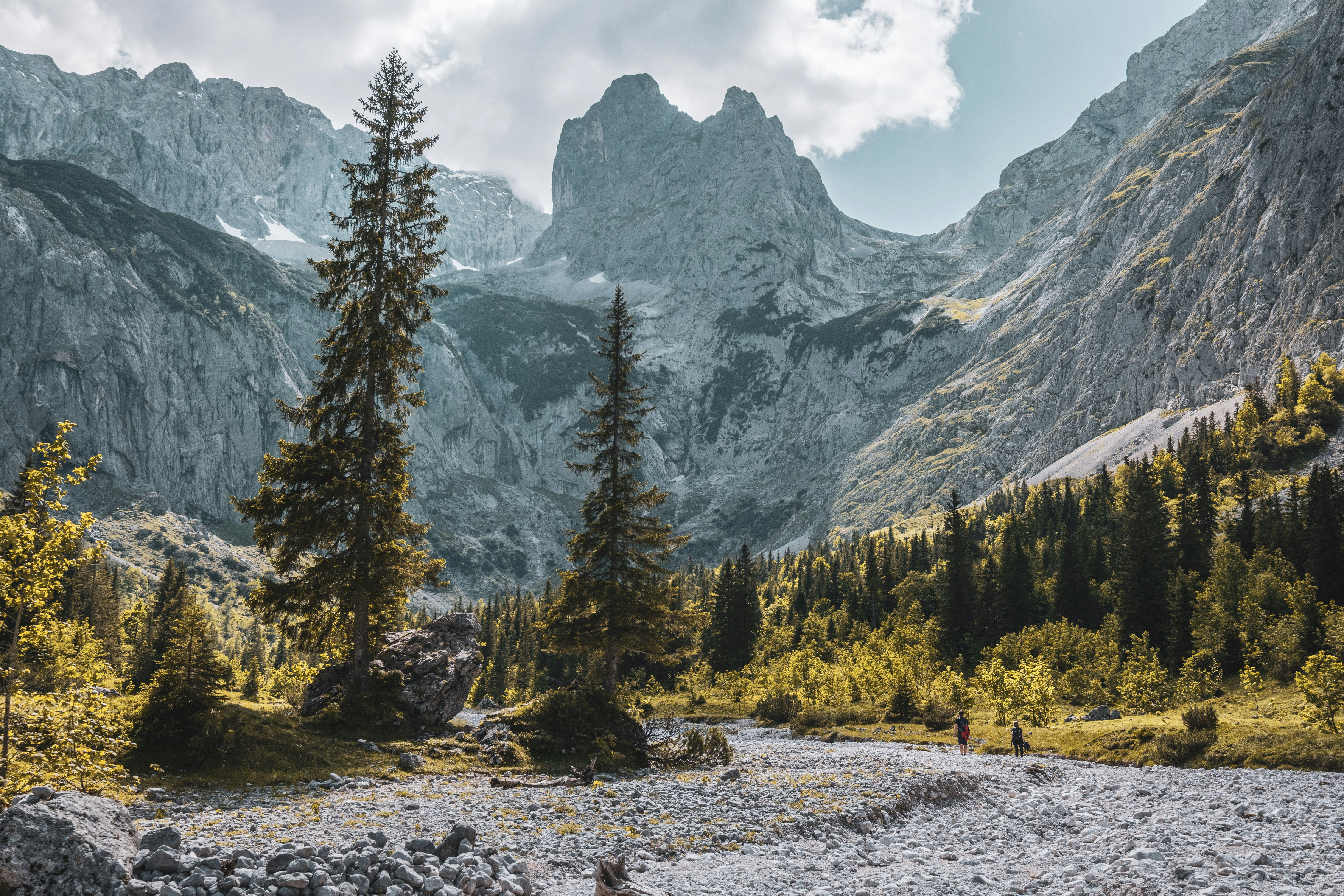 a river running through a valley between mountains