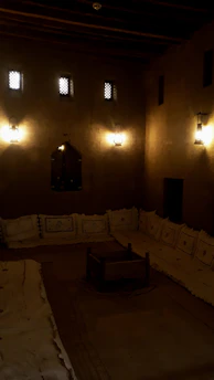 An intimate dining setup in a traditional riad courtyard with lanterns and Moroccan decor.
