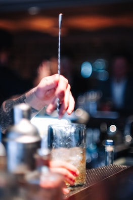 Close-up of a robotic arm mixing drinks.