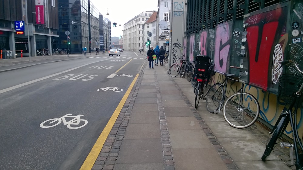 a street with a wall with graffiti