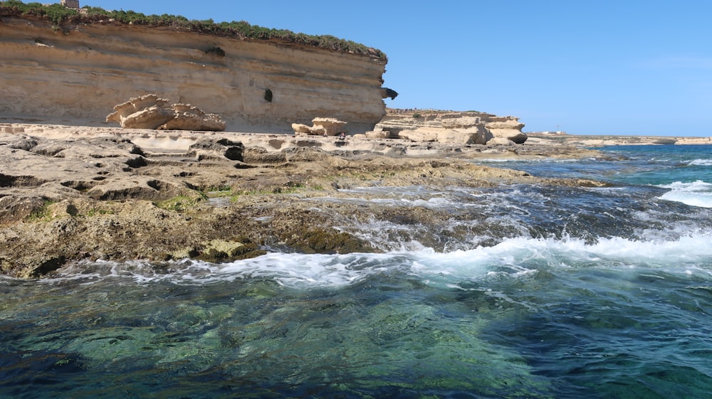 a rocky beach with waves crashing