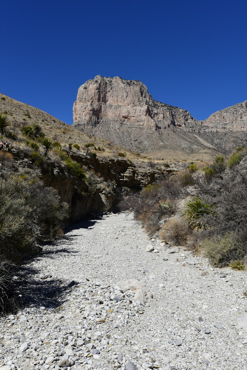 a rocky mountain with a blue sky