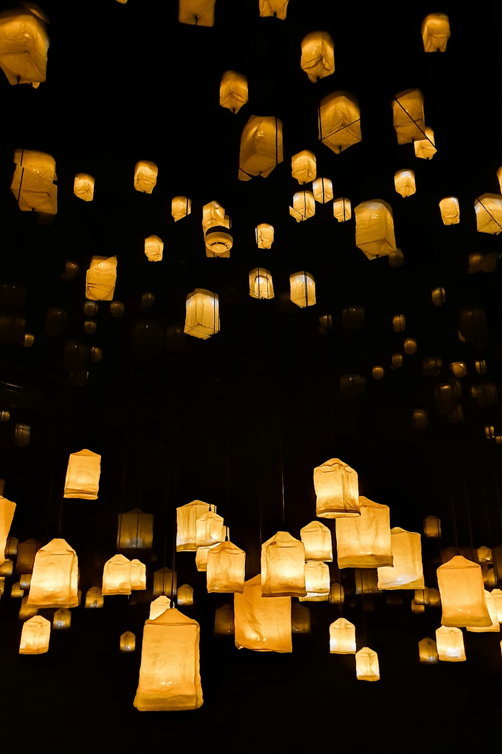 a group of lanterns floating in the air